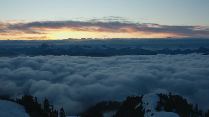 Aerial view of clouds on top of a hill with trees