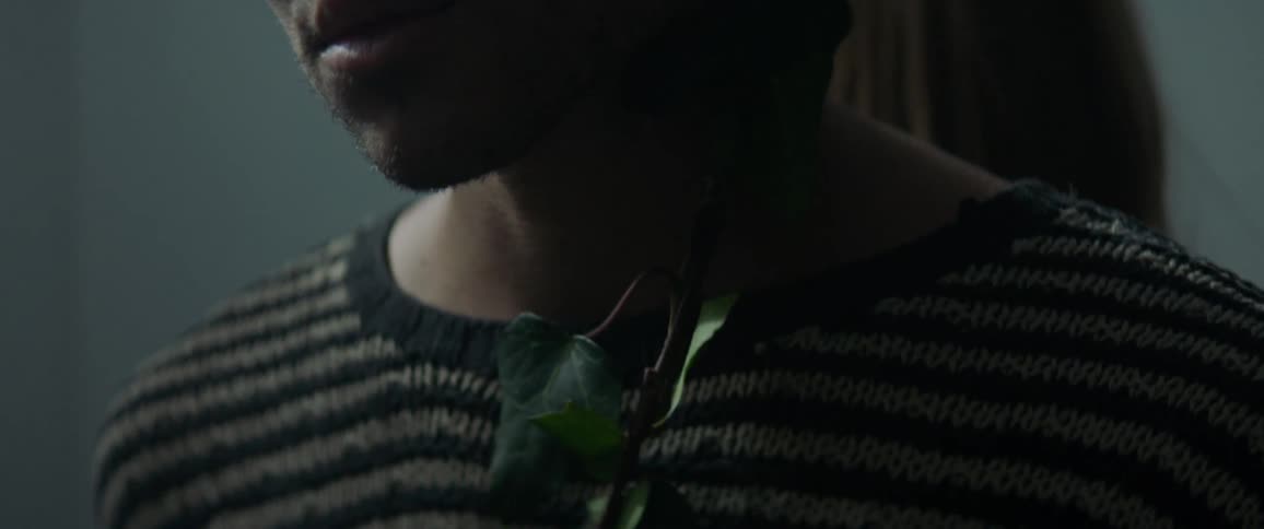 Vines are wrapped around a man's body