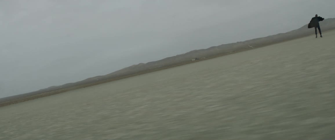 Clouds float above an empty dirt field