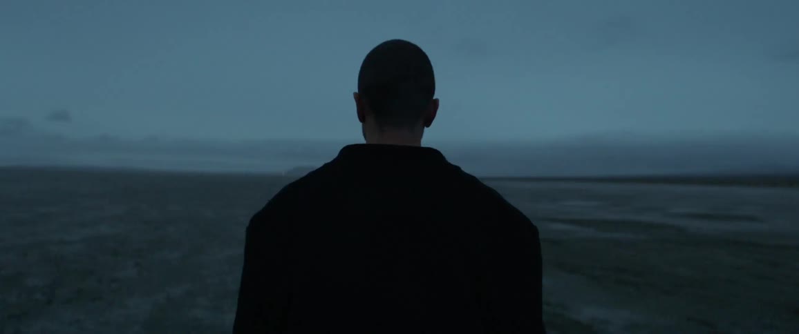 A man walks through an open field