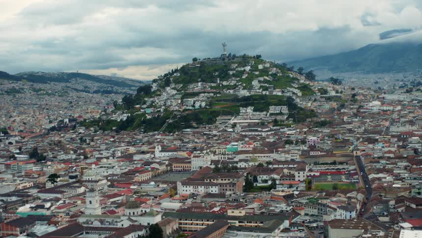 Small third world city in a valley with a small hill in the center