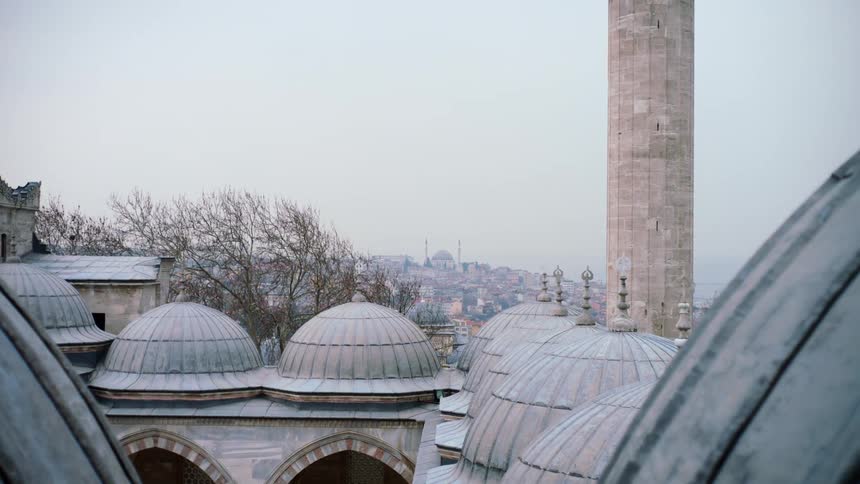 Mosque with a minaret and domes around the mosque courtyard