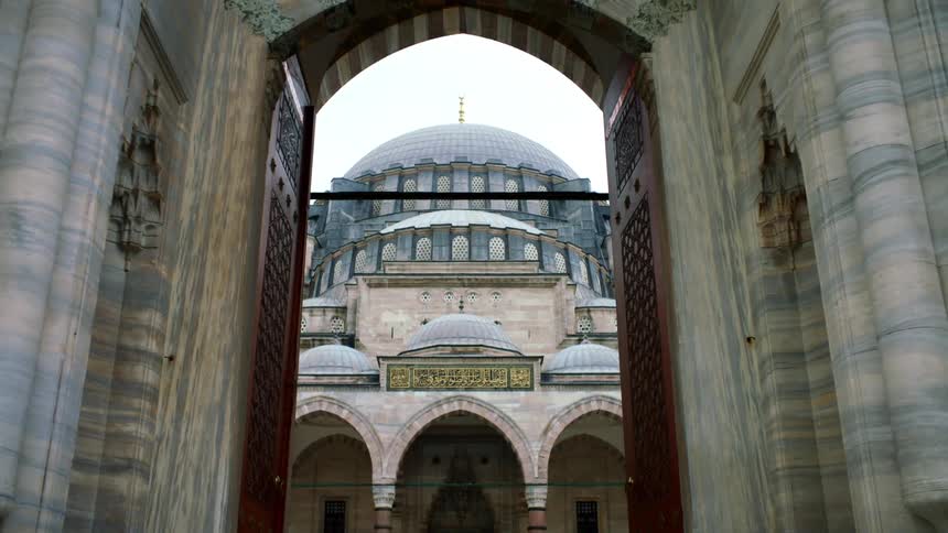 A domed building with large brown doors