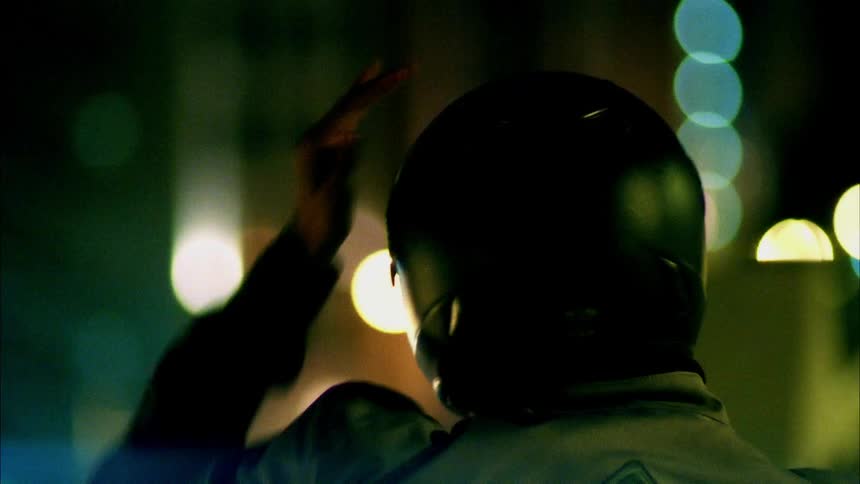 A man puts on his motorcycle helmet
