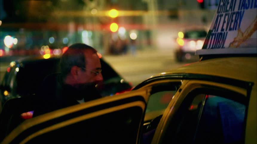 A taxi driver gets out and opens the taxi door for a woman who gets in