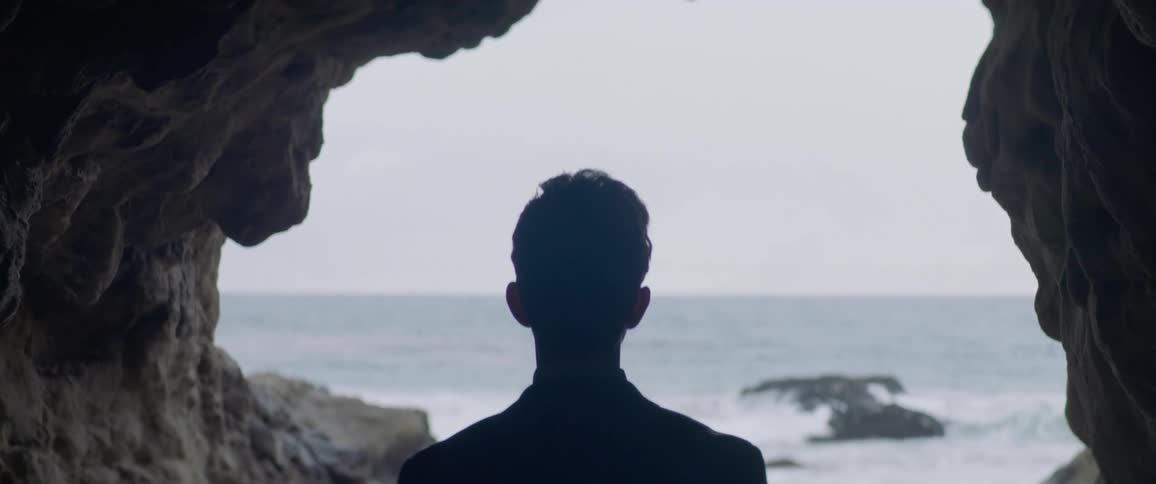 A man walks out of a cave