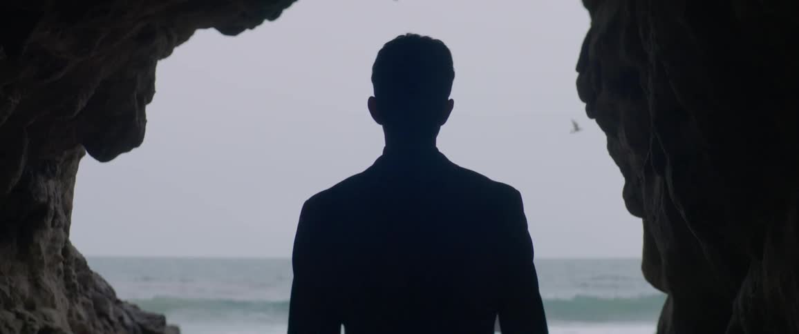 A man looks out towards the ocean