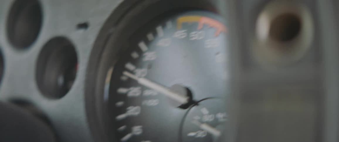 Gauges on a car dashboard rise as a car accelerates