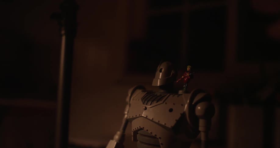 Close up of a toy robot in a dark room