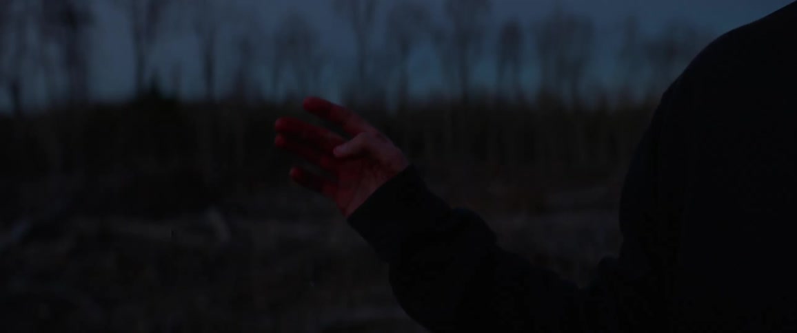 A man flicks a cigarette on the ground