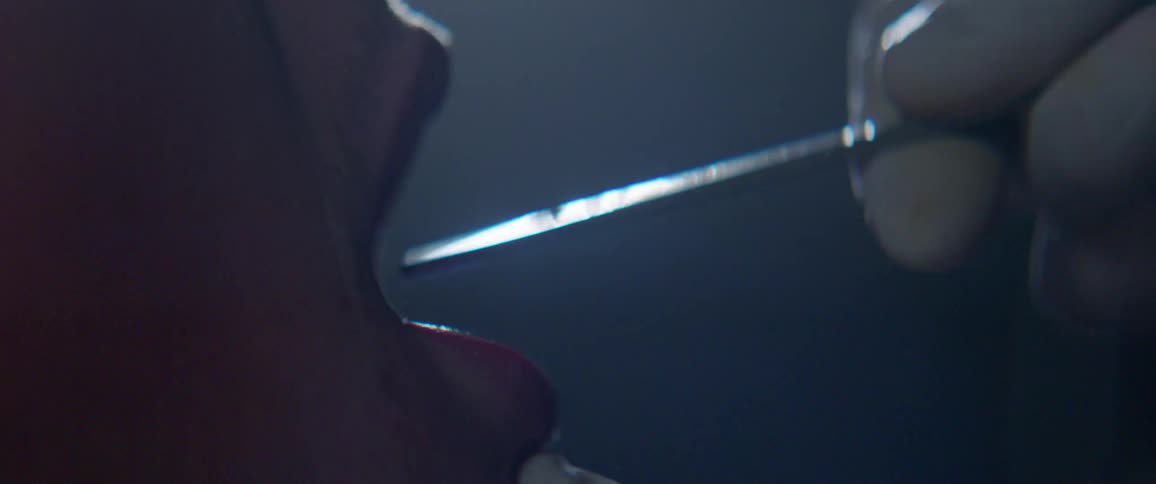 A medical instrument is inserted into a person's mouth