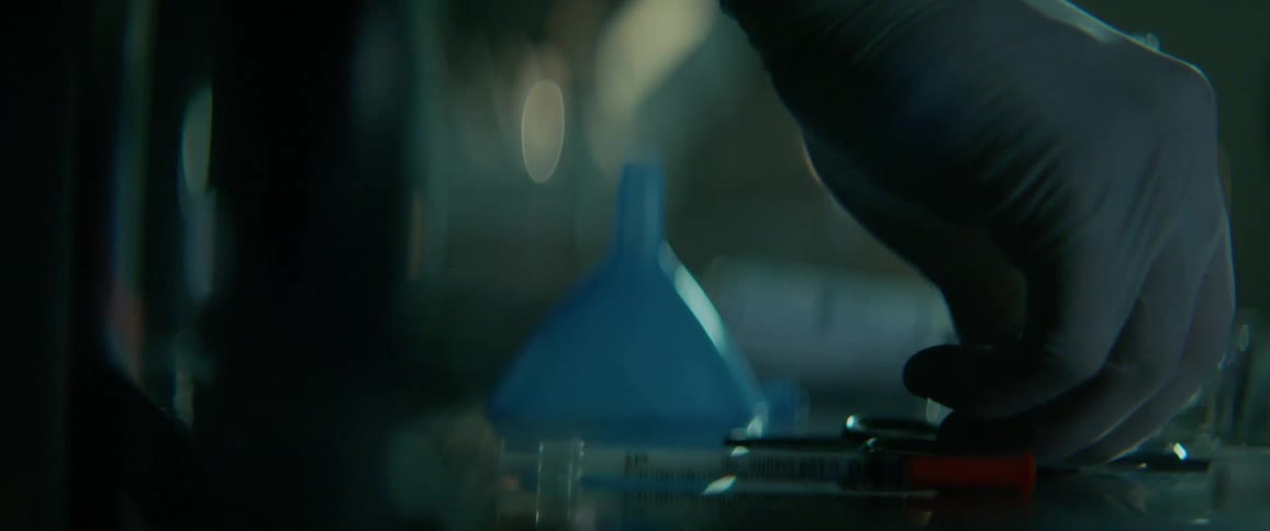 A man is working with various implements in a lab