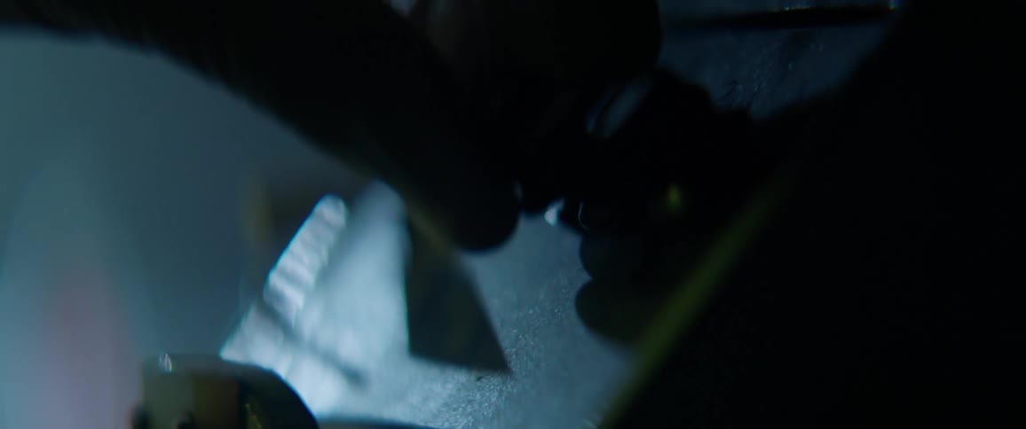 A person adjusts nobs on a machine