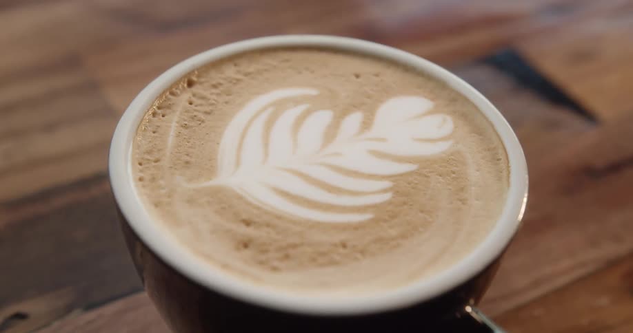 A foamy latte on a wood table