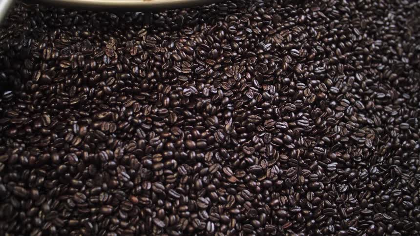 Coffee beans being stirred by an agitator