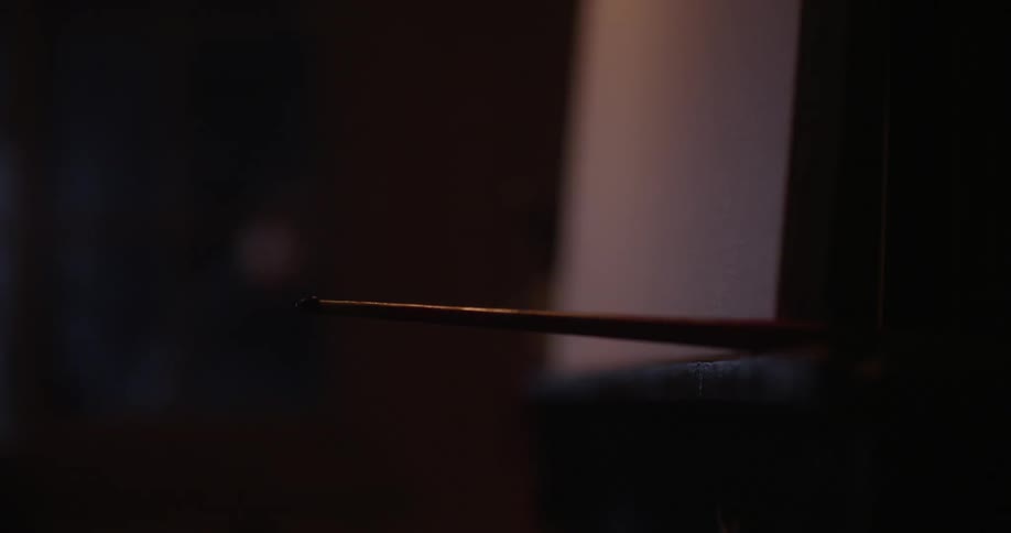 A drumstick sits on a ledge