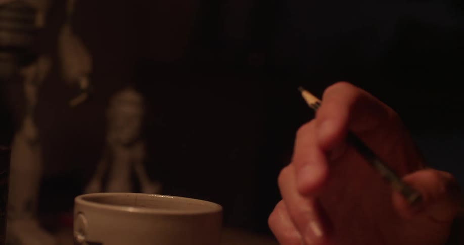 A person taps a pencil in their hand