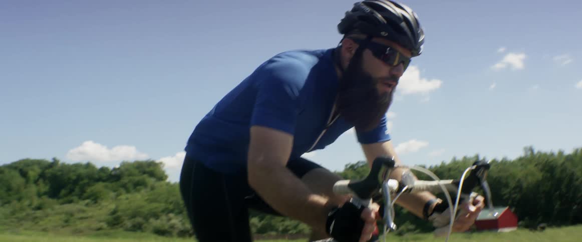 A man riding a bicycle on a rural road