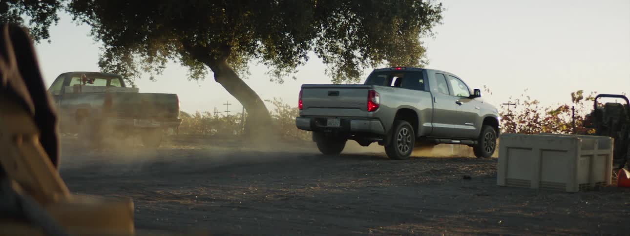 A person is driving a truck in a rural area