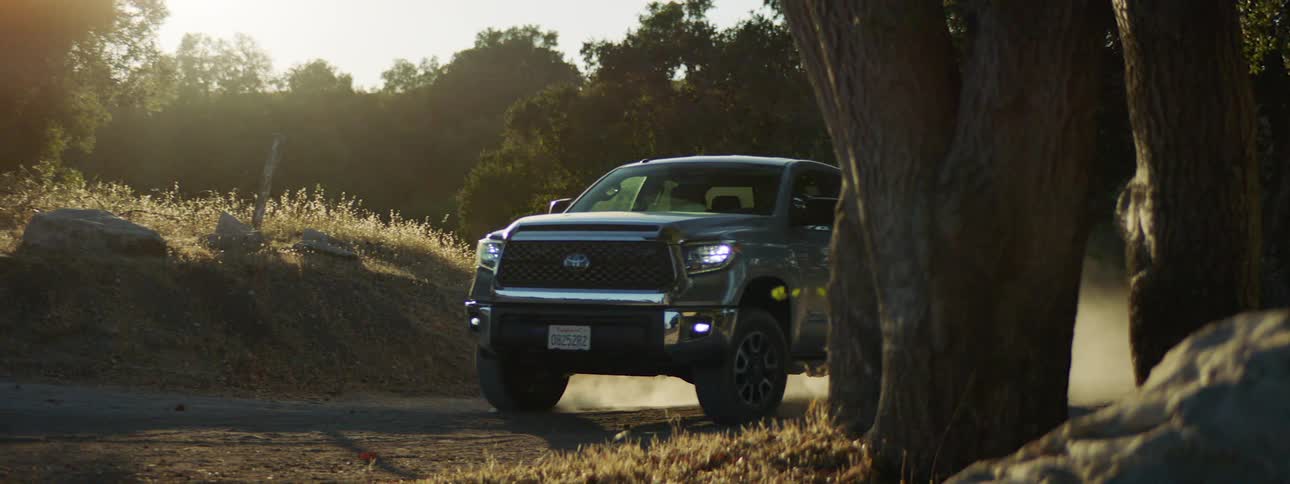 A truck turns around the bend in the forest