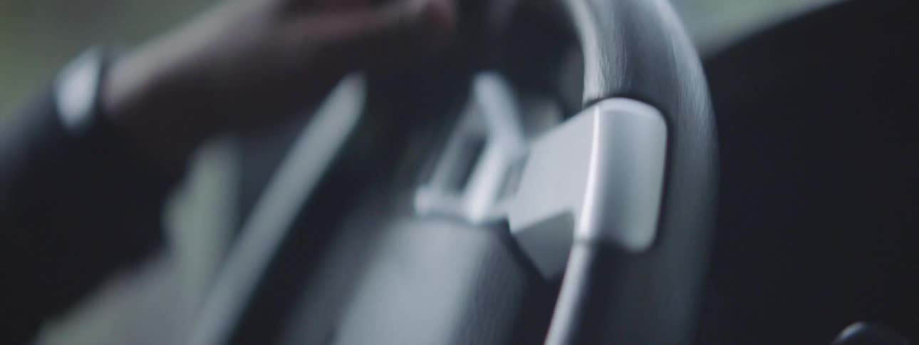 A person is driving a car in the daytime