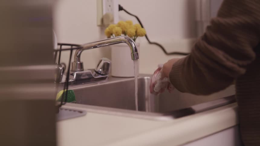 A person is washing their hands in the sink