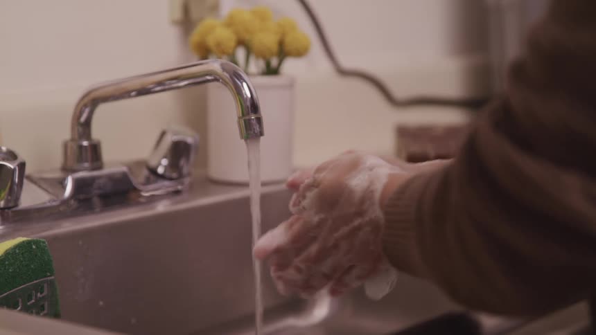 A person is washing their hands in the sink