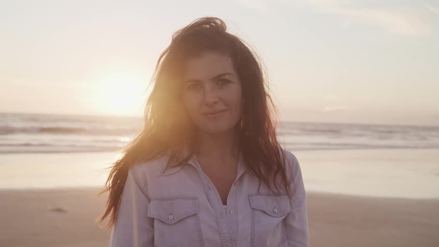 A woman smiling on the beach