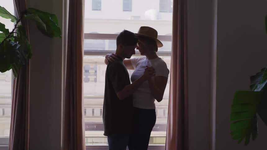 A man and woman dancing at home