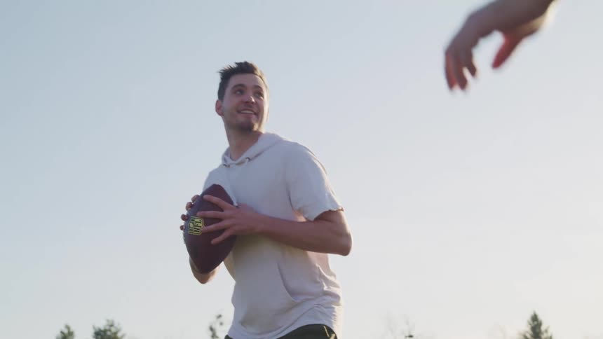 Two people playing football together