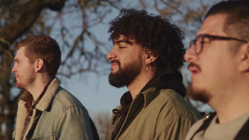 A group of friends are standing outdoors