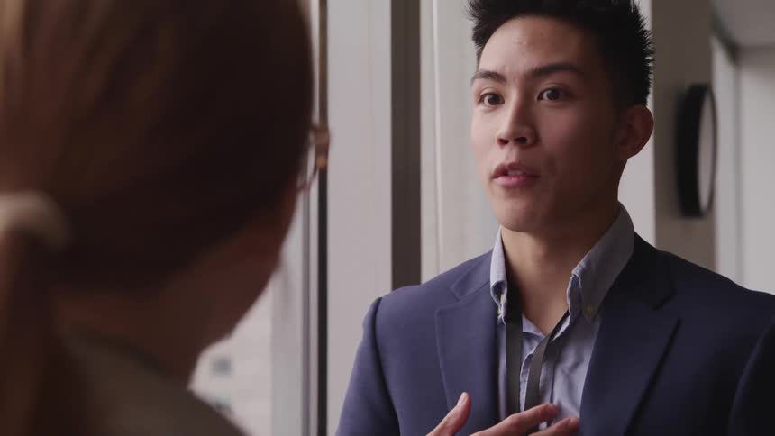 Two office workers chatting in an office building