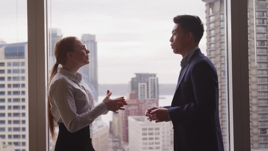 A man and woman talking in an office