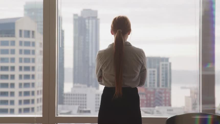A woman is standing in an office building