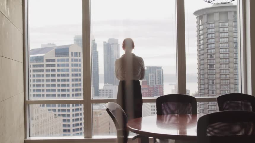 A woman is standing in an office building