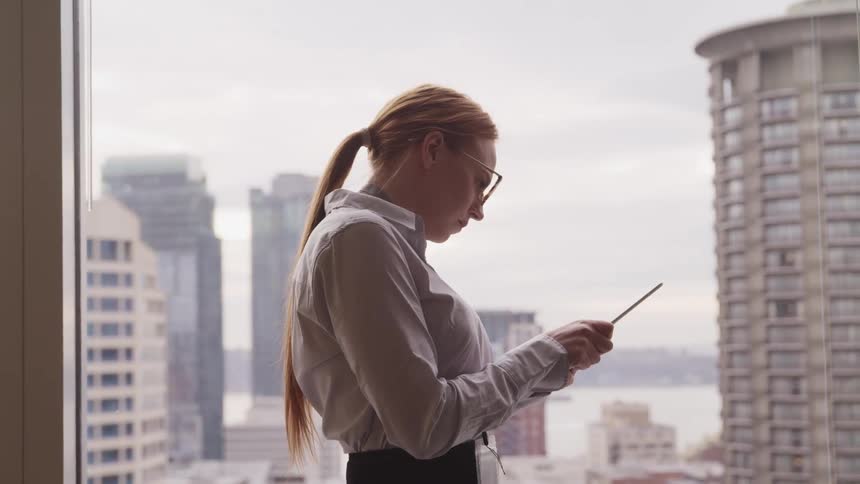 A woman is standing in an office building