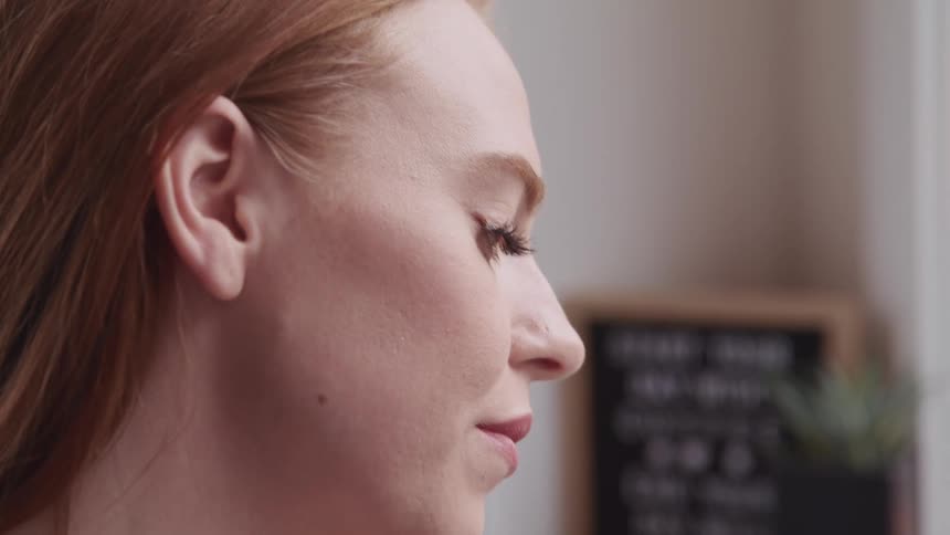 A woman inside looks down