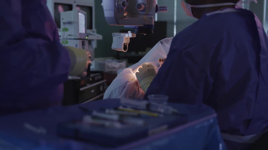 Surgeons performing surgery on a patient in a hospital