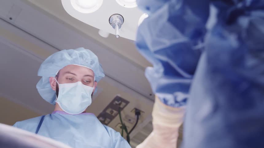 Team of surgeons performing an operation in an operating room