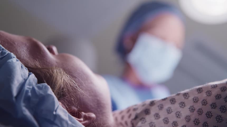 A doctor is operating on a patient