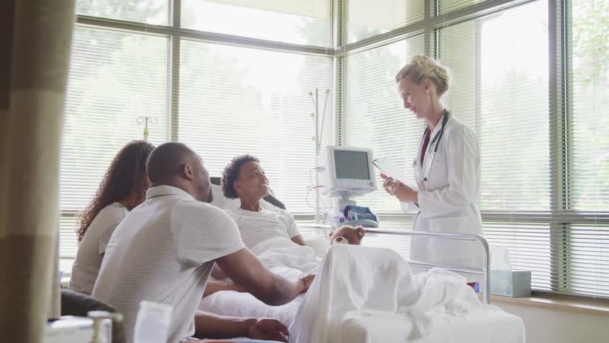 A doctor talks to a patient in the hospital