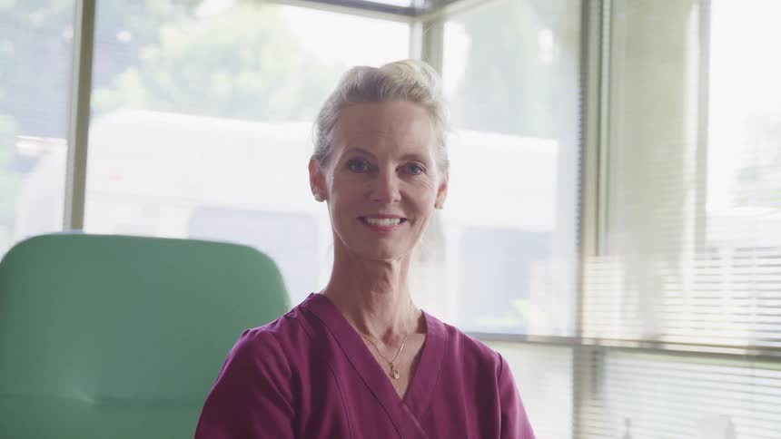 A nurse sits in the hospital room