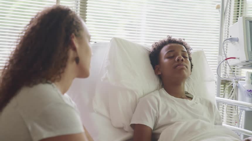 A woman is visiting someone in the hospital