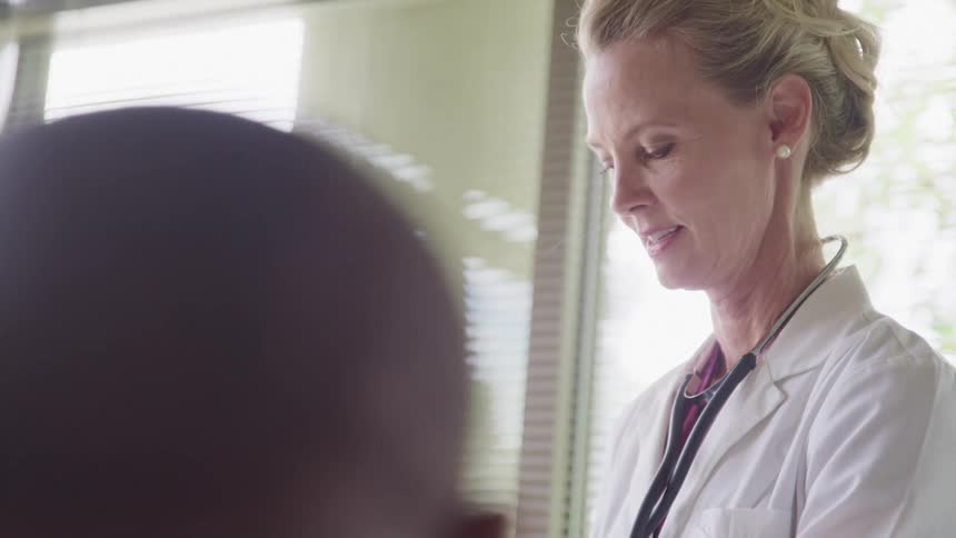 A doctor in a hospital room with a patient