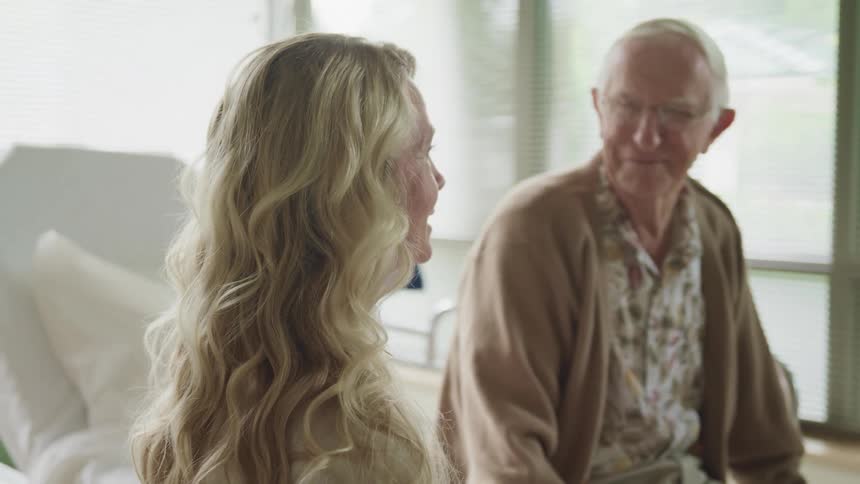 A man and woman talk in the hospital
