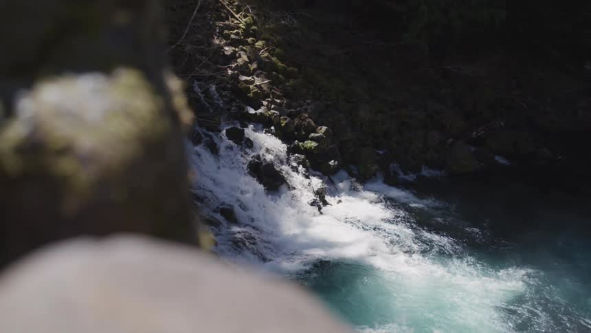 An aerial view of a waterfall is displayed