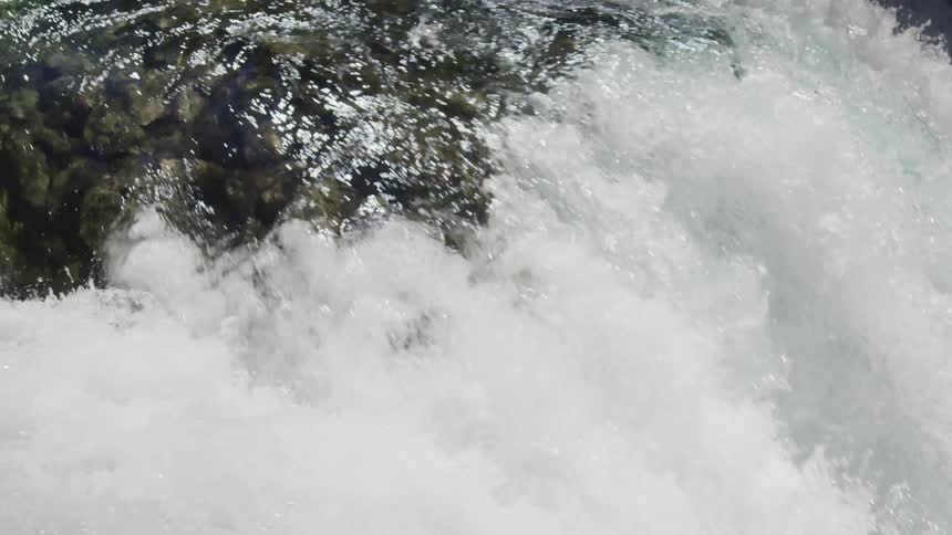A waterfall crashing in to the river below