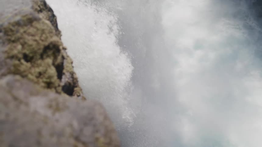A waterfall crashing in to the river below