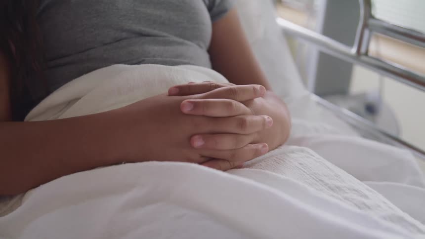 A woman lying in a hospital bed