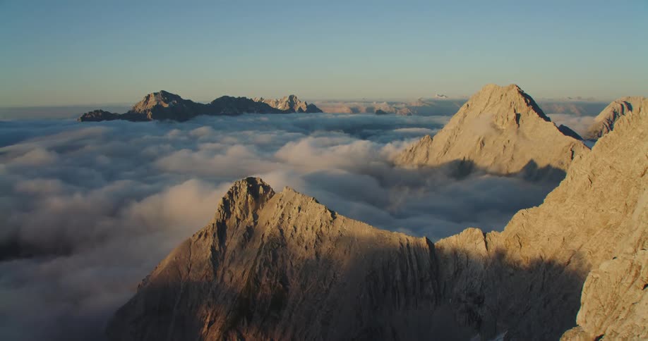 An aerial view of mountain tops is displayed